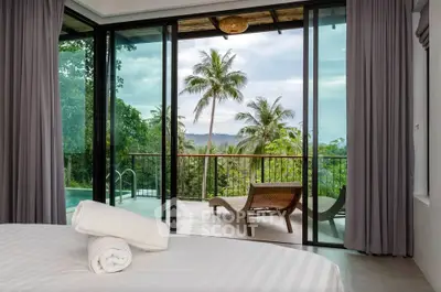 Luxurious bedroom with stunning tropical view and private balcony access.