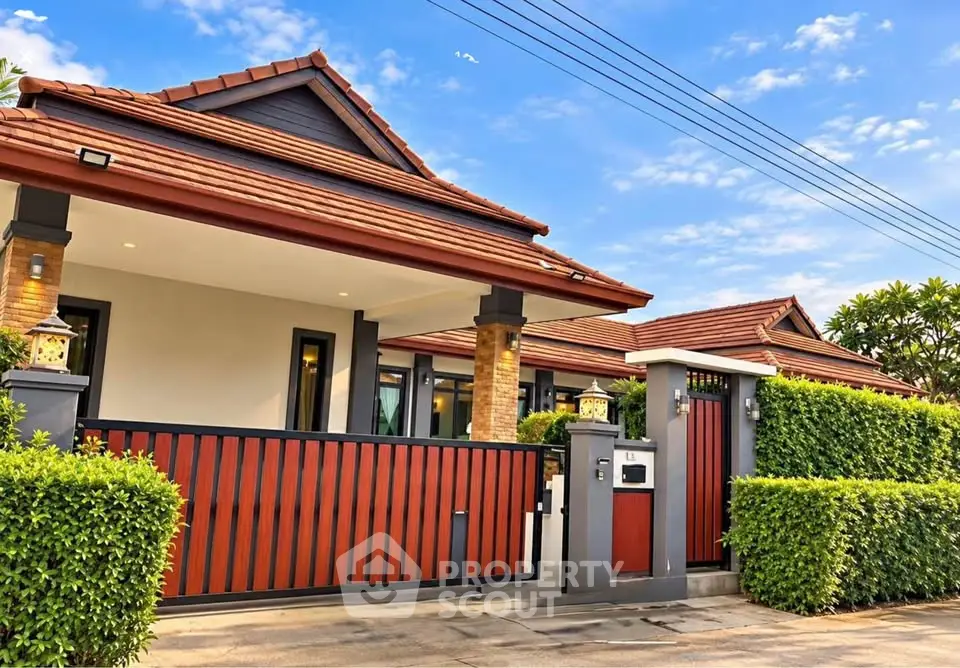 Charming single-story home with red-tiled roof and modern fence in a serene neighborhood.