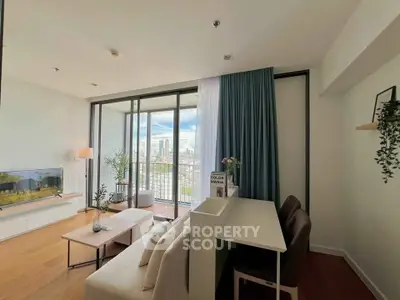 Modern living room with balcony and city view, featuring stylish decor and natural light.