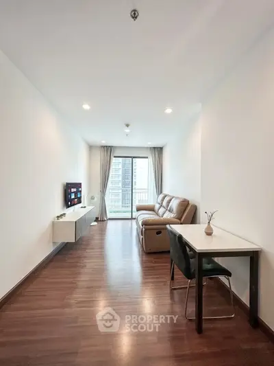Modern living room with sleek furniture and city view balcony