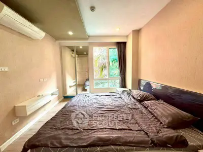 Spacious bedroom with modern decor and large window view