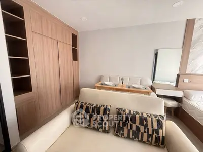 Modern studio apartment with stylish decor and built-in storage solutions.