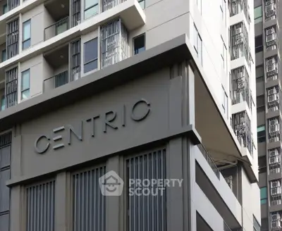 Modern high-rise building exterior with sleek architectural design and large windows.