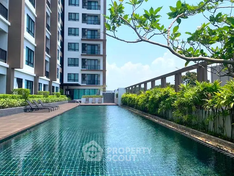 Luxurious condominium with a stunning outdoor pool and lush greenery, perfect for relaxation and leisure.