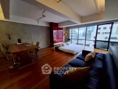 Spacious modern living room with city view, featuring open layout and stylish furnishings.