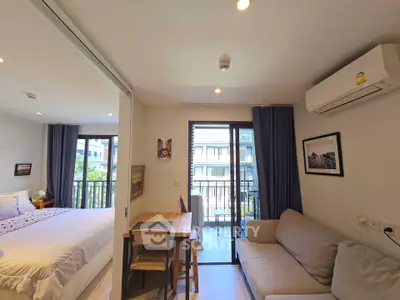 Modern apartment interior with cozy living room, bedroom, and balcony view.