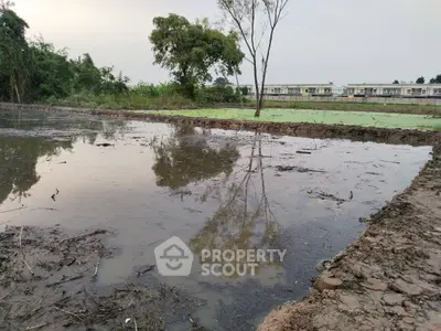 Expansive land with water feature, ideal for development opportunities.