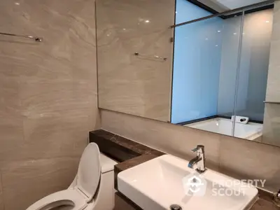 Modern bathroom with sleek design and large mirror