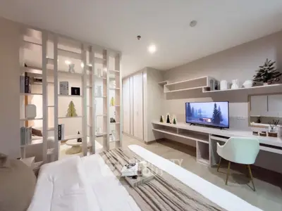 Modern bedroom with stylish decor, built-in shelves, and cozy workspace