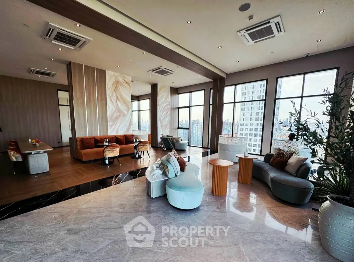 Luxurious modern living room with panoramic city views and elegant furnishings.