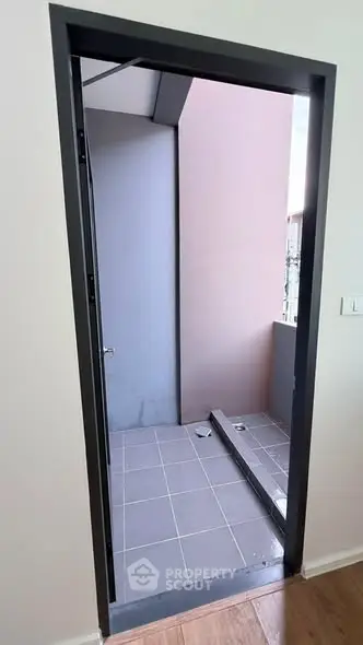 Modern apartment balcony with sleek design and tiled flooring, perfect for urban living.