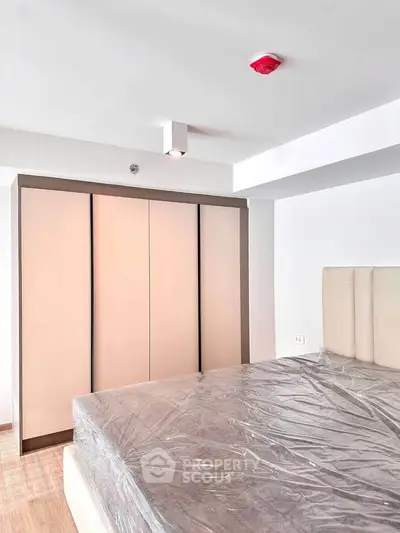 Modern bedroom with sleek wardrobe and bed in minimalist design