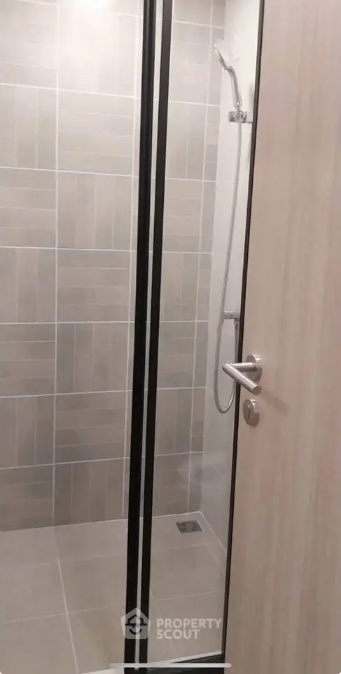 Modern bathroom with sleek shower design and neutral tiles