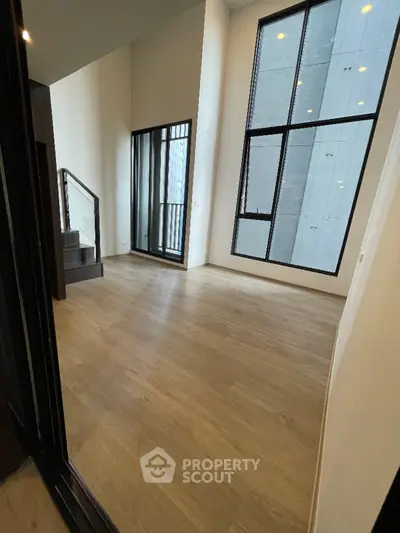 Spacious modern living room with high ceilings and large windows