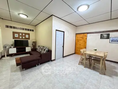 Spacious living room with modern furniture and dining area, perfect for family gatherings.