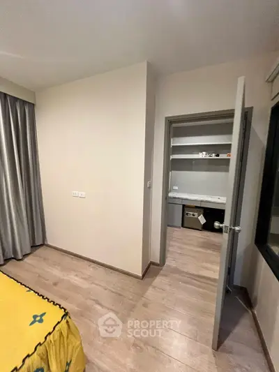 Modern bedroom with wooden flooring and open closet space