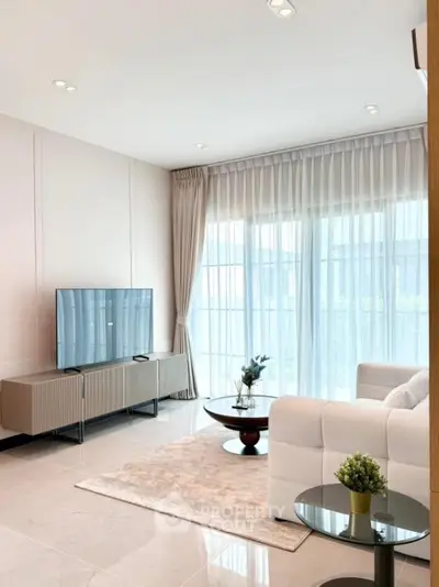 Modern living room with large windows and elegant decor