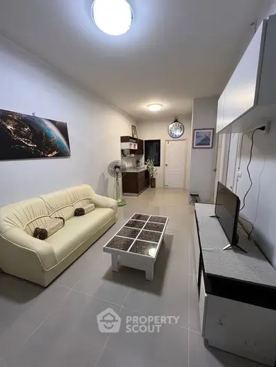 Modern living room with sleek furniture and stylish decor, perfect for comfortable living.