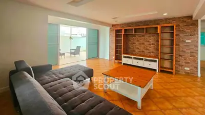 Spacious living room with modern furniture and large sliding doors to patio.