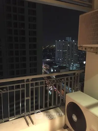 Stunning city view from high-rise balcony at night, perfect for urban living.