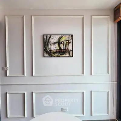 Elegant interior wall with modern art in a stylish living room setting.