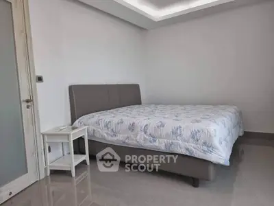 Modern bedroom with sleek design and comfortable bed in a stylish apartment.