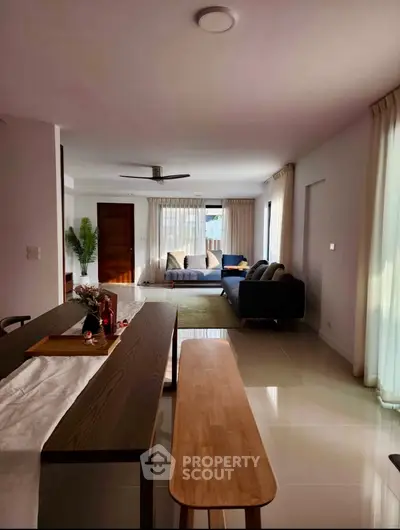 Spacious modern living room with elegant decor and ample natural light