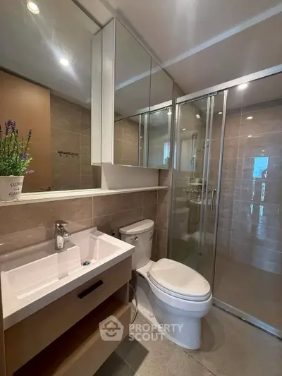 Modern bathroom with glass shower and sleek fixtures
