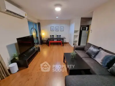 Modern living room with sleek furniture and open layout, featuring a cozy sofa and stylish decor.