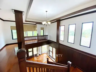 Spacious two-story living area with wooden accents and large windows