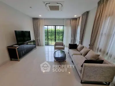 Spacious modern living room with large windows and elegant furnishings