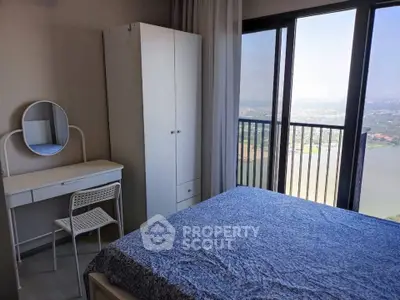Cozy bedroom with stunning balcony view and modern furnishings.