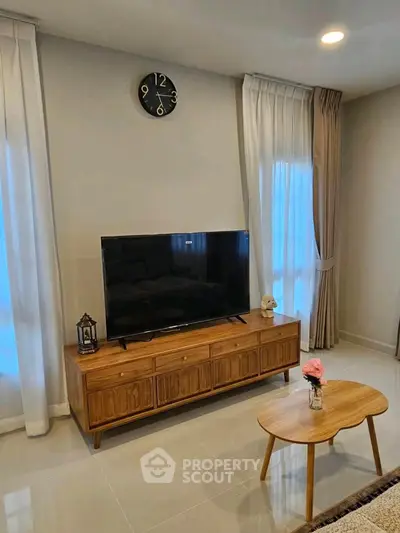 Modern living room with stylish wooden TV stand and elegant decor