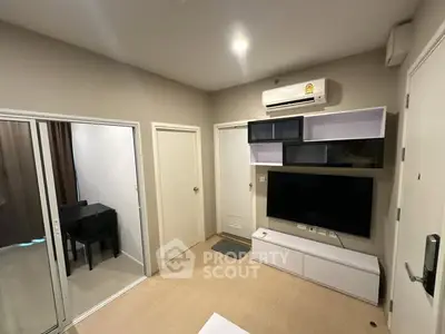 Modern living room with sleek TV unit and air conditioning