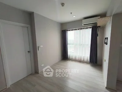 Bright and airy room with large window and modern flooring