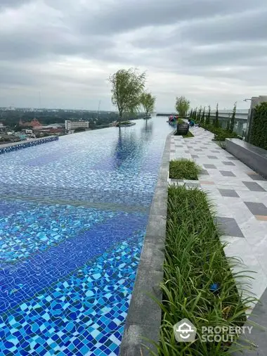 Luxurious rooftop infinity pool with panoramic city views, offering a serene escape and perfect for upscale urban living.