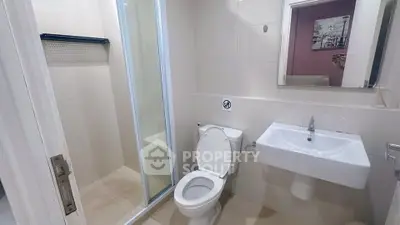 Modern bathroom with sleek fixtures and glass shower enclosure