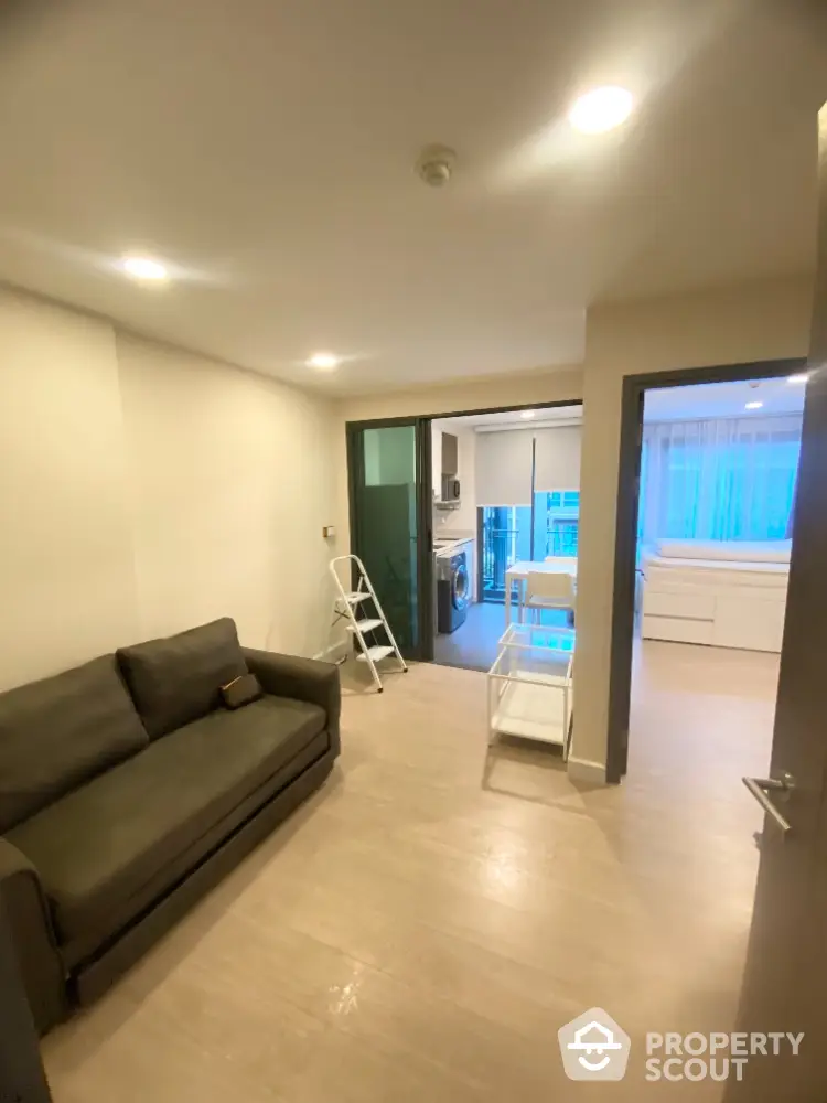 Modern living room with sofa and open view to kitchen area