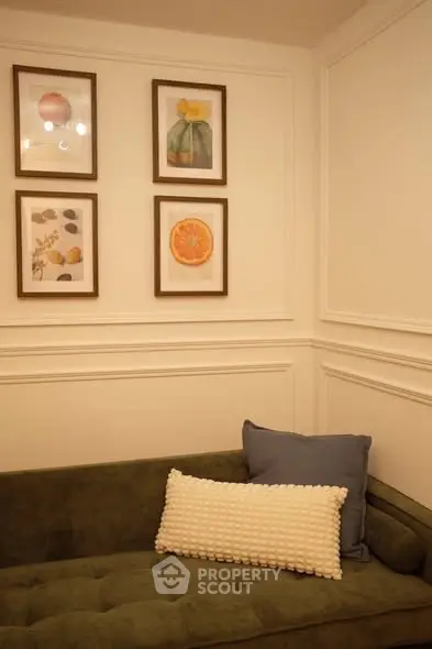 Chic living room with elegant wall art and plush green sofa