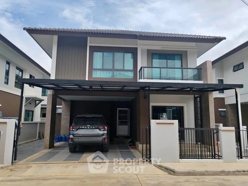 Modern two-story house with carport and sleek design in suburban neighborhood.