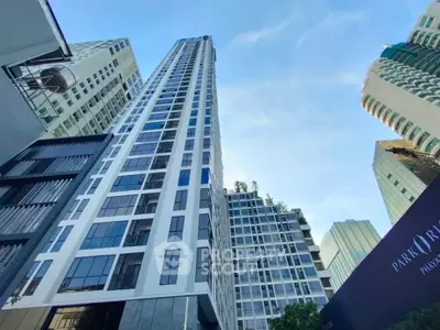 Stunning high-rise building with modern architecture and skyward view in urban setting.