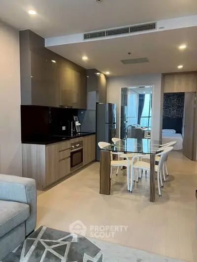 Modern open-layout kitchen and dining area with sleek appliances and stylish decor.