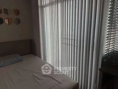 Cozy bedroom with vertical blinds and soft lighting