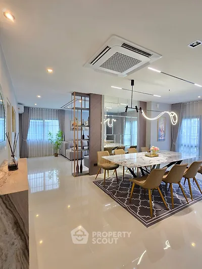 Luxurious open-plan dining area with modern lighting and elegant decor