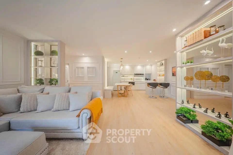 Spacious open-plan living room with modern kitchen and elegant decor
