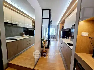 Modern kitchen with sleek cabinetry and open layout in a stylish apartment.