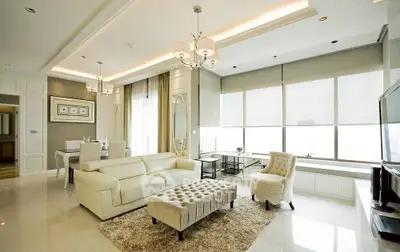 Luxurious modern living room with elegant decor and large windows.