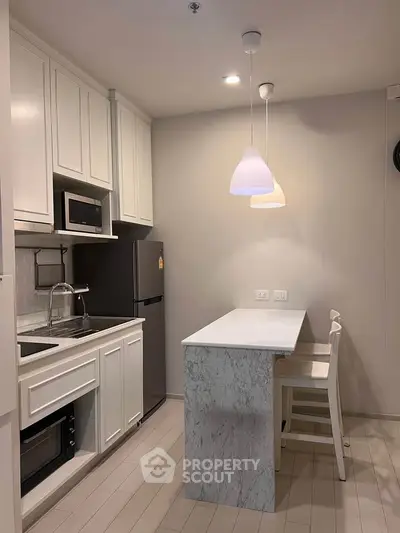 Modern kitchen with marble island and sleek white cabinetry