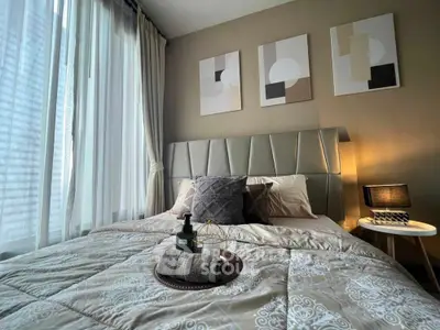 Modern bedroom with stylish decor and large window for natural light