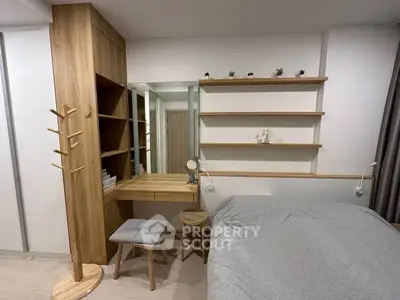 Modern bedroom with wooden furniture, built-in shelves, and cozy decor